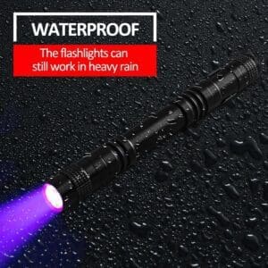 A waterproof flashlight emitting purple light on a wet surface.