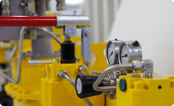 Close-up of industrial machinery with yellow components and metal parts.