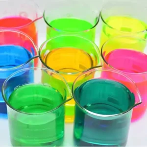 Colorful translucent liquids in small plastic cups arranged together.