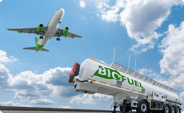 An airplane flying above a biofuel refueling truck under a partly cloudy sky.