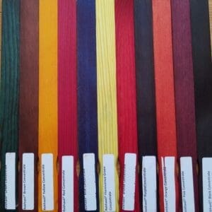 Various colored pencils neatly aligned in a row with their sharpened tips facing up.