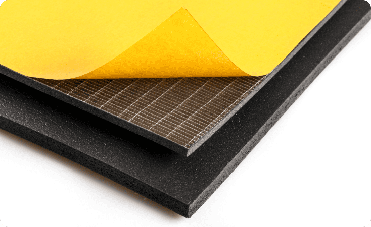 Stack of layered materials with a yellow top sheet and black base.